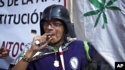 A supporter of the legalization of marijuana smokes outside the Supreme Court in Mexico City, Nov. 4, 2015. 