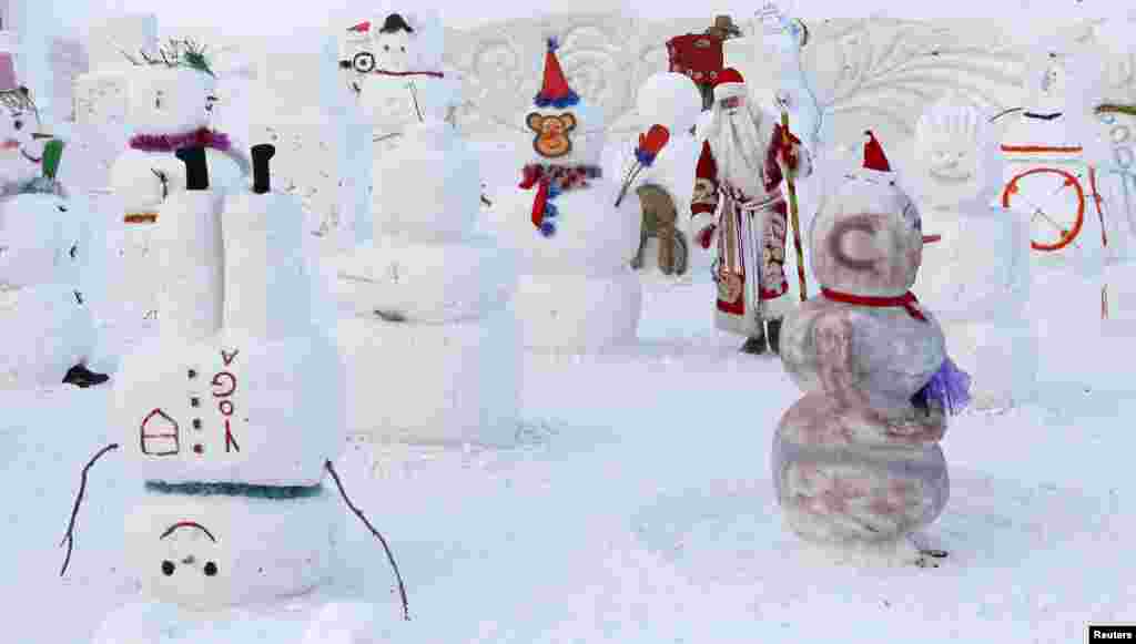 បុរសម្នាក់ស្លៀកពាក់ជា Ded Moroz (ឬលោកតា Frost) ក្នុងភាសារុស្ស៊ីដែលមានន័យថា Santa Claus ដើររើសមនុស្សព្រិលល្អបំផុត ក្នុងពិធីប្រកួតប្រជែងដែលមានឈ្មោះថា Parade of Snowmen នៅឧទ្យាន Royev Ruchey Flora and Fauna Park នៅជាយក្រុង Krasnoyarsk ប្រទេសរុស្ស៊ី។