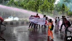 Bangladeshi policemen use water cannon to disperse activists protesting against the removal of a Lady Justice statue in Dhaka, Bangladesh, May 26, 2017. A Lady Justice statue was removed from Bangladesh's Supreme Court premises under tight security overnight after Islamist hardliners pressed for its removal for months, the sculptor said Friday.