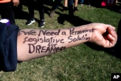 Ivon Meneses of Las Vegas wrote "We need a permanent legislative solution for Dreamers" on her arm as she and other supporters of the Deferred Action for Childhood Arrivals program attended an action in support of DACA recipients, March 5, 2018, on Capitol Hill.