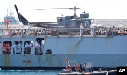 Inmigrantes a bordo del barco Aquarius Orione de la ONG francesa "SOS Mediterranee", llegan al puerto oriental de Valencia, España, el domingo 17 de junio de 2018.