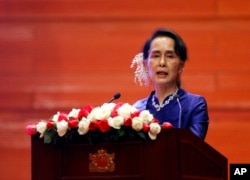 FILE - Myanmar's leader Aung San Suu Kyi speaks during the signing ceremony of "Nationwide Cease-fire Agreement" at Myanmar International Convention Center in Naypyitaw, Myanmar, Feb. 13, 2018.