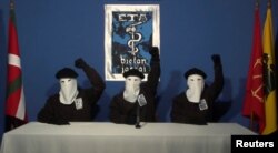 FILE PHOTO - Three members of Basque separatist group ETA call for a definitive end to 50 years of armed struggle, which has cost the lives of at least 850 people, in this still image taken from an undated video published on the website of Basque language