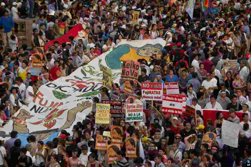 Demonstrators take part in a protest against presidential candidate Keiko Fujimori and against the 1992 coup by her father, former President Alberto Fujimori, in downtown Lima, Peru, April 5, 2016.