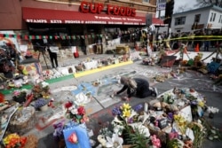 A person places flowers at the George Floyd Square after the announcement of the verdict in the trial of former Minneapolis police officer Derek Chauvin, who is facing murder charges in the death of George Floyd, in Minneapolis, Minnesota, U.S