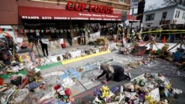 A person places flowers at the George Floyd Square after the announcement of the verdict in the trial of former Minneapolis police officer Derek Chauvin, who is facing murder charges in the death of George Floyd, in Minneapolis, Minnesota, U.S