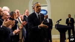 President Barack Obama walks over to shake hands with people after speaking at a meeting of law enforcement leaders from across the country about immigration reform, in the Eisenhower Executive Office Building on the White House in Washington, May 13, 201
