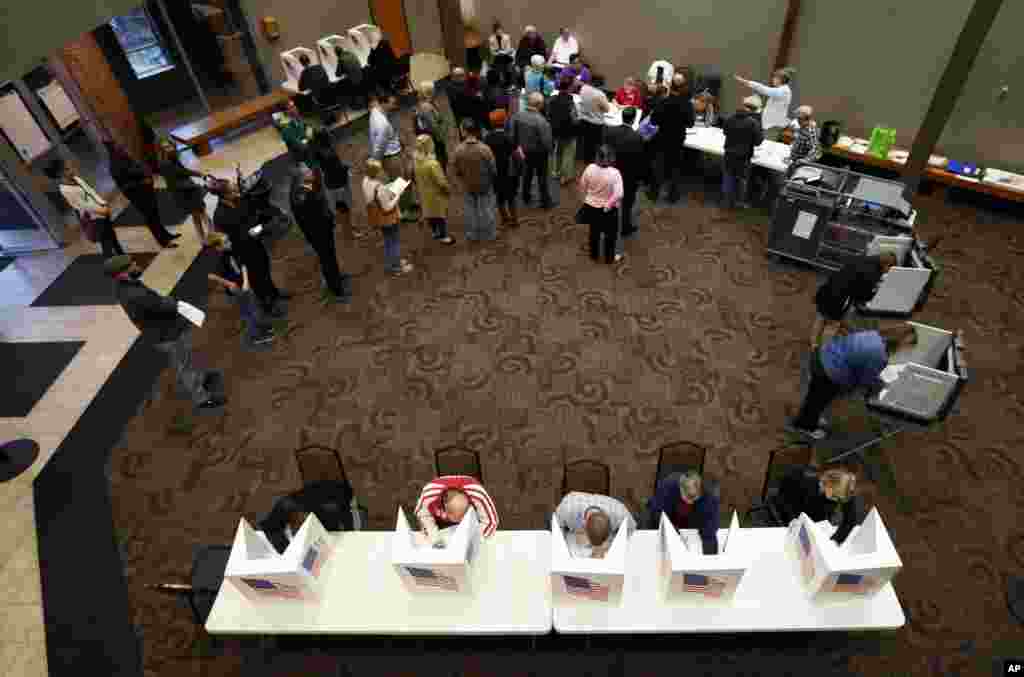 Local residents cast their ballots in the general election in precinct 39 at the First Church of the Open Bible, Nov. 8, 2016, in Des Moines, Iowa.