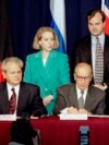 President Slobodan Milosevic of Serbia (L), President Alija Izetbegovic of Bosnia-Herzegovina (C) and President Franjo Tudjman of Croatia sign the Dayton Agreement peace accord at the Hope Hotel inside Wright-Patterson Air Force Base in this November 21, 