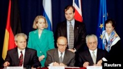 President Slobodan Milosevic of Serbia (L), President Alija Izetbegovic of Bosnia-Herzegovina (C) and President Franjo Tudjman of Croatia sign the Dayton Agreement peace accord at the Hope Hotel inside Wright-Patterson Air Force Base in this November 21, 