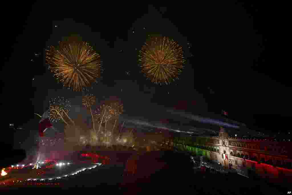 Fireworks displays are seen in front of Metropolitan Cathedral after Mexican President Andres Manuel Lopez Obrador gave the annual independence shout to kick off Independence Day celebrations, at the Zocalo in Mexico City, Sept. 15, 2020.
