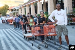 Customers wait in a line to purchase materials to secure their homes, as Hurricane Irma approches Florida, at a Home Depot store in North Miami, Florida, Sept. 6, 2017.