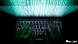 FILE - A man types on a computer keyboard in this illustration, Feb. 28, 2013. A U.S.-based cybersecurity intelligence group says that it has seen Iranian state hackers using more ransomware.