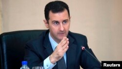 Syria's President Bashar al-Assad heads a cabinet meeting in Damascus, in this handout photograph distributed by Syria's national news agency SANA, Feb. 12, 2013.