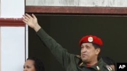 Venezuela's President Hugo Chavez greets supporters from a balcony of Miraflores presidential palace next to his daughter Rosa Virginia in Caracas, Venezuela, July 4, 2011.
