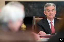 FILE - Jerome Powell attends a Board of Governors meeting Nov. 30, 2015, at the Marriner S. Eccles Federal Reserve Board Building in Washington.