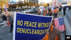 Protesters march toward the U.S. Embassy during a rally supporting the United States' policy to put steady pressure on North Korea in Seoul, South Korea, Nov. 3, 2018.