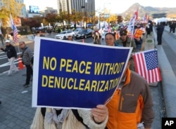 Protesters march toward the U.S. Embassy during a rally supporting the United States' policy to put steady pressure on North Korea in Seoul, South Korea, Nov. 3, 2018.