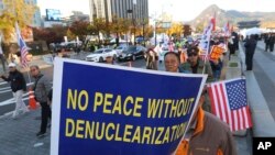 FILE - Protesters march toward the U.S. Embassy during a rally supporting the U.S. policy to put steady pressure on North Korea, in Seoul, South Korea, Nov. 3, 2018. 
