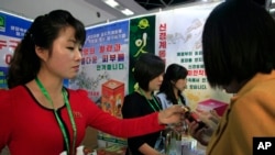 FILE - North Koreans look at products at an international trade fair held Sept. 25, 2017, in Pyongyang.