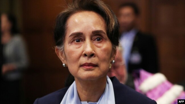 FILE - Myanmar's leader Aung San Suu Kyi arrives at the International Court of Justice in The Hague, Netherlands Dec. 11, 2019. A court in Myanmar postponed its verdict in the trial of ousted leader Suu Kyi to allow testimony from an additional witness.