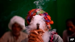 An Indian villager smokes tobacco in New Delhi, India, 2013. A World Health Organization study says tobacco-related diseases cost India about $22 billion in 2011.