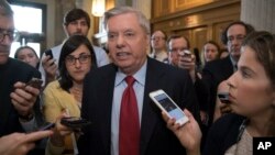 Sen. Lindsey Graham, R-S.C. is surrounded by reporters as he arrives at the Senate on Capitol Hill in Washington, July 27, 2017.