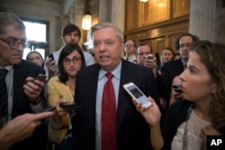 Sen. Lindsey Graham, R-S.C., is surrounded by reporters as he arrives at the Senate on Capitol Hill in Washington, July 27, 2017.