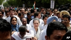 India's opposition Congress party president Sonia Gandhi, front centre, accompanied by her son and party vice-president Rahul Gandhi, behind, lead a march against the ruling Bharatiya Janata Party (BJP) government in New Delhi, India on May 6, 2016. 