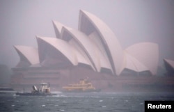 Ferries and boats pass in front of the Sydney Opera House as strong winds and heavy rain hit the city of Sydney, Australia, Nov. 28, 2018.