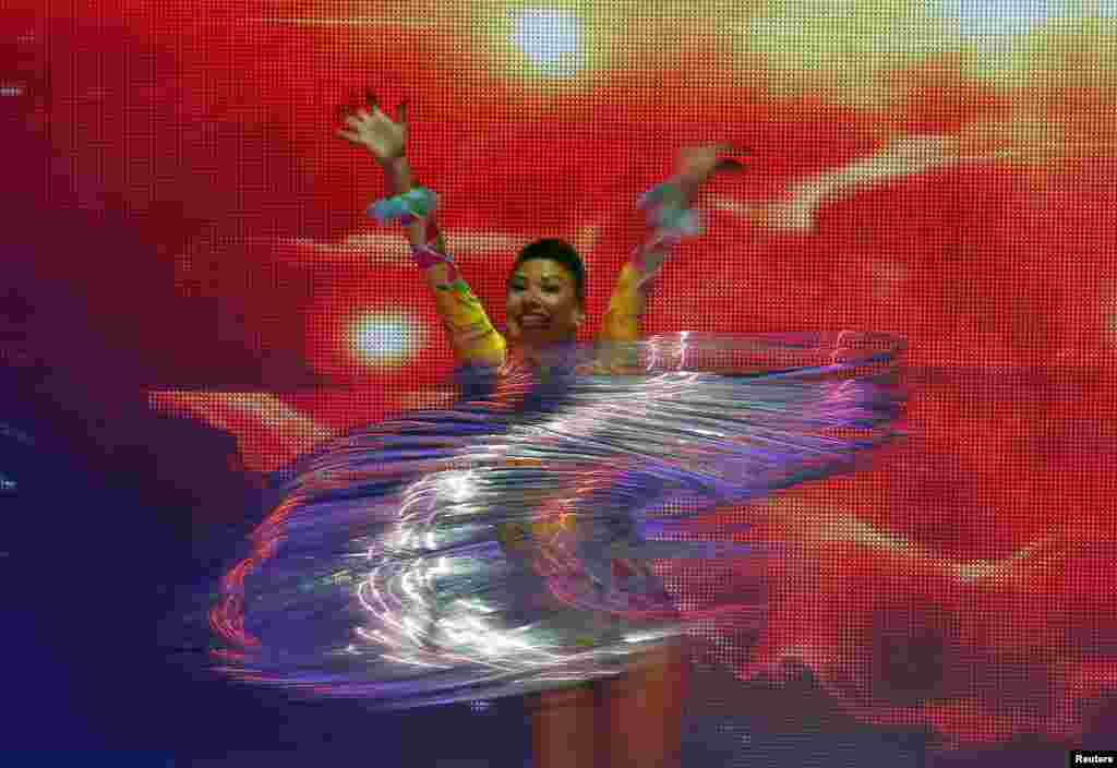 A dancer swings metal rings during an ice-skating show as part of the Ocean Park Christmas performances in Hong Kong.