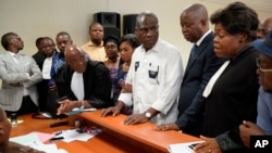 FILE - Accompanied by his wife and his lawyers, Congo opposition candidate Martin Fayulu, center, petitions the constitutional court following his loss in the presidential elections in Kinshasa, Congo, Jan. 12, 2019. 