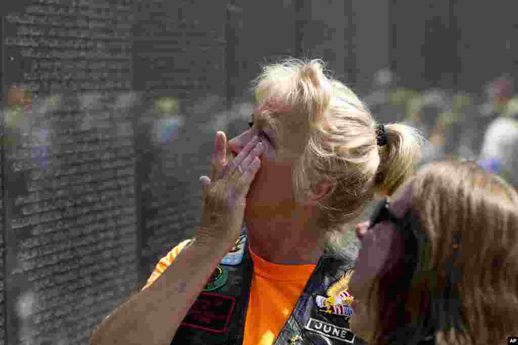 June Allums Flowers looks at the name of her brother Allen W. Allums at Vietnam Veterans Memorial wall ahead of Memorial Day, May 27, 2018, in Washington.