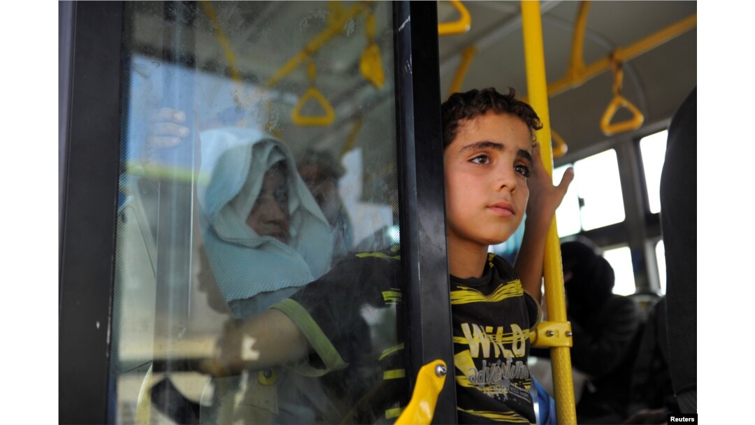 Civilians ride a bus to be evacuated from the besieged Damascus suburb of Daraya, after an agreement reached on Thursday between rebels and Syria's army, Syria, August 26, 2016.