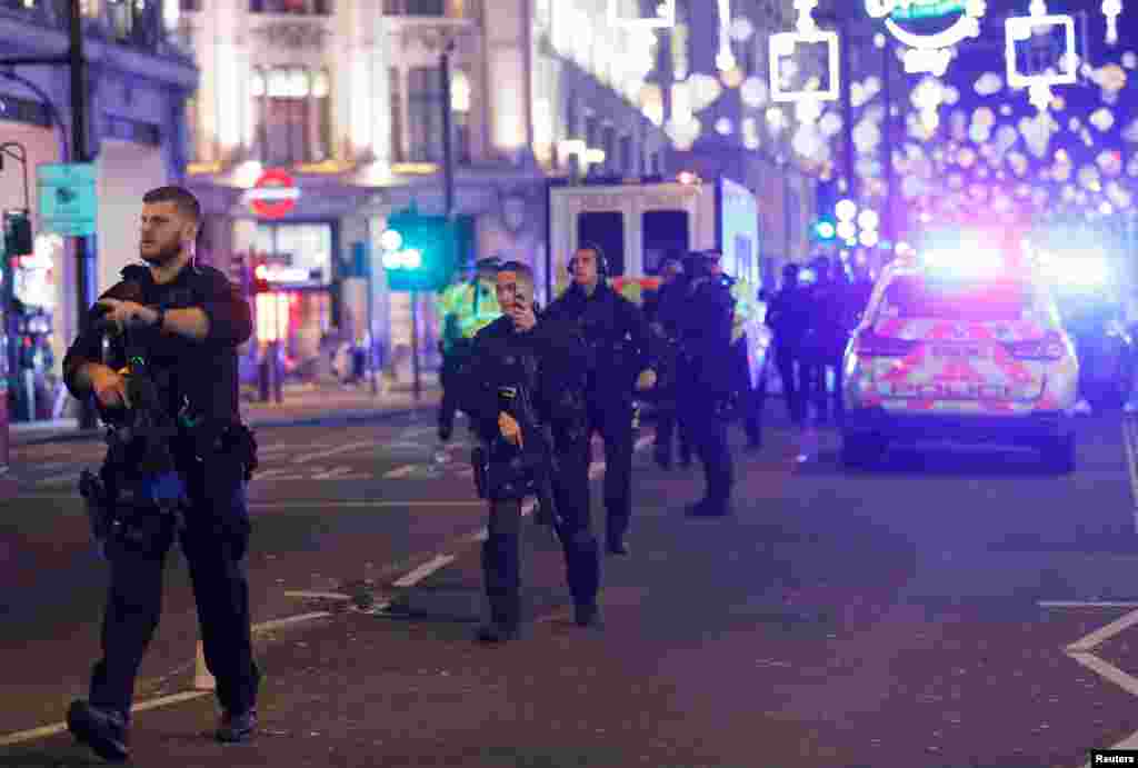 Armed police walk along Oxford Street, London, Britain Nov. 24, 2017.