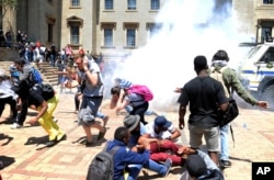 Students and police clash on the University of the Witwatersrand campus in Johannesburg South Africa on Monday, Oct. 10, 2016.