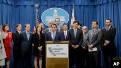 Assembly Speaker Anthony Rendon, D-Paramount, center, discusses a pair of proposed measures to protect immigrants, during a news conference in Sacramento, Calif., Dec. 5, 2016.