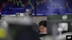 A trader watches the computer monitors in Seoul, South Korea. Online trading can easily be done at home and has increased during under coronavirus measures. File (AP Photo/Lee Jin-man)