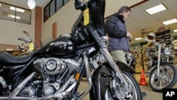 Customers admire and look at the new Harley-Davidson motorcycles at the Hall's Harley Davidson dealership in Springfield, Ill. Harley-Davidson's second-quarter profit more than doubled as it posted its first U.S. sales increase since 2006, (File)