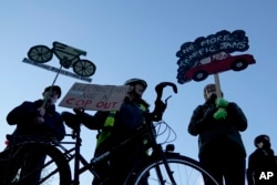 People take part in a pro-cycling demonstration outside the SEC (Scottish Event Campus) venue for the COP26 U.N. Climate Summit, in Glasgow, Scotland, Nov. 10, 2021.
