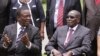 FILE: President Emmerson Mnangagwa, left, chatting with Robert Mugabe.