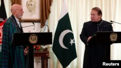 Pakistan's Prime Minister Nawaz Sharif (R) speaks during a joint news conference as Afghan President Hamid Karzai listens at the prime minister's residence in Islamabad, Aug. 26, 2013.