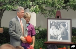 President Bill Clinton is presented a photograph of his meeting with President Kennedy in 1963 when he was member of Boys Nation.