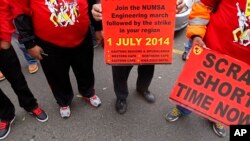 Members of the National Union of Metal Workers of South Africa, NUMSA, hold banners as they protest with others during national strike action in Cape Town, South Africa, July 1, 2014.