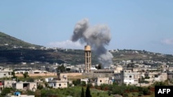Smoke billows following bombardment by regime forces on the village of Basamis, Idlib province, Syria, May 4, 2019.
