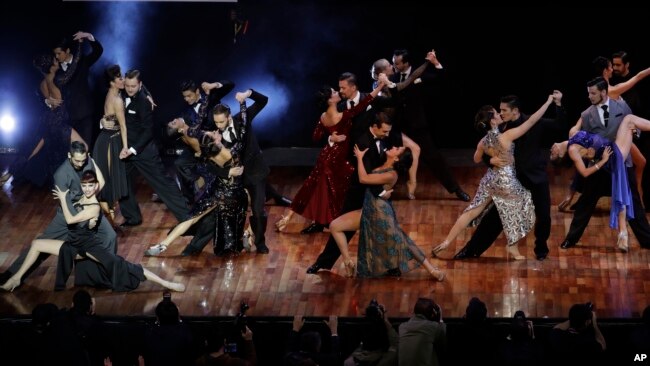 Couples dance before the announcement of the winners in the stage category at the World Tango Championship final in Buenos Aires, Argentina, Wednesday, Aug. 23, 2017. (AP Photo/Natacha Pisarenko)