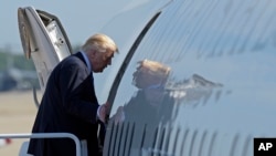 FILE - President Donald Trump boards Air Force One at Andrews Air Force Base in Md.