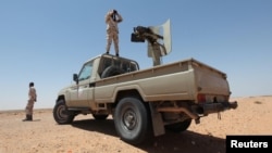 FILE - Libyan forces allied with the U.N.-backed government patrol to prevent Islamic State resurgence on the outskirts of Sirte, Libya, Aug. 4, 2017. 