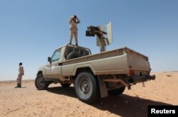 FILE - Libyan forces allied with the UN-backed government patrol to prevent Islamic State resurgence on the outskirts of Sirte, Libya, Aug. 4, 2017.