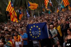 Pro-independence supporters hold a European Union flag during a rally in Barcelona, Spain, Oct. 10, 2017.